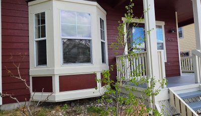 house exterior with dark red and grey painted siding and white trim