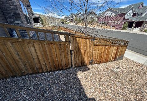 worn wooden fence outside of home before staining