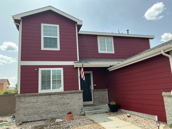 front door and walkway of house with red siding Preview Image 5