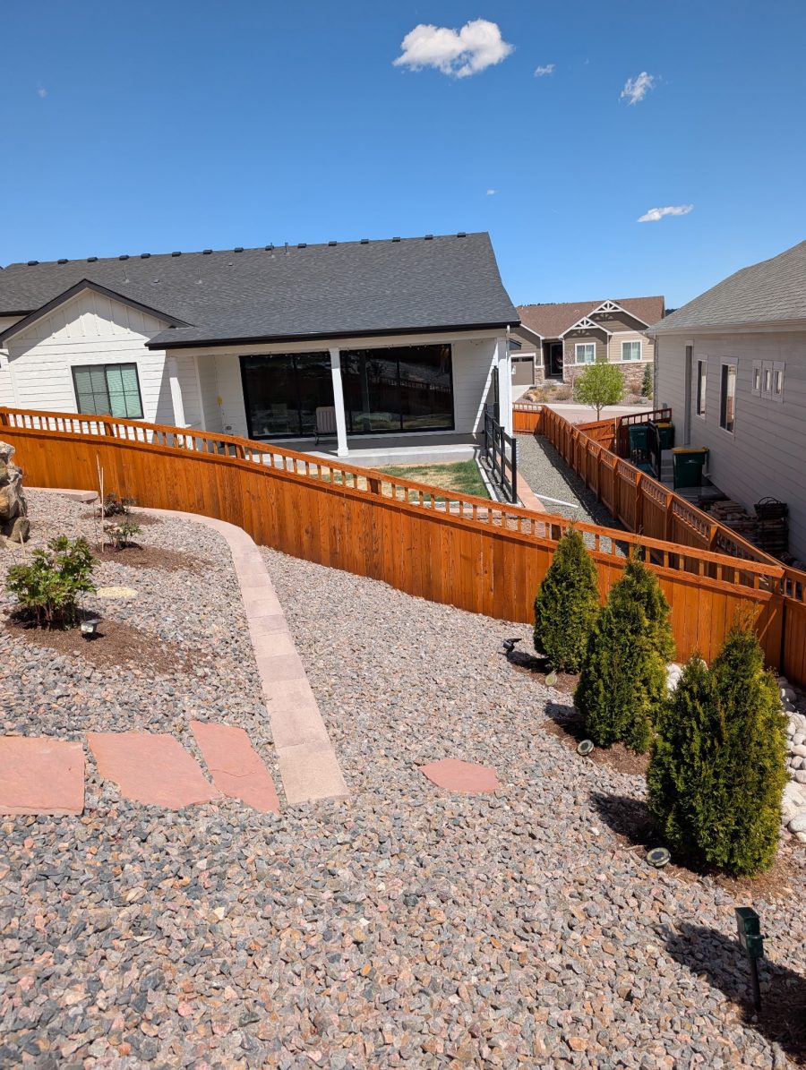 gravel ground cover outside houses with stained wooden fence dividing several houses Preview Image 2