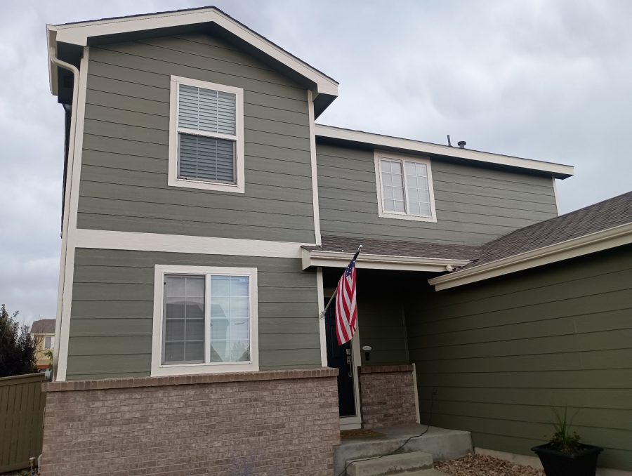 house with sage green painted siding