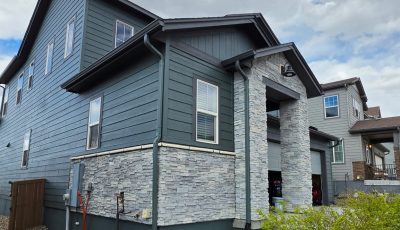 house exterior with dark teal siding after repaint