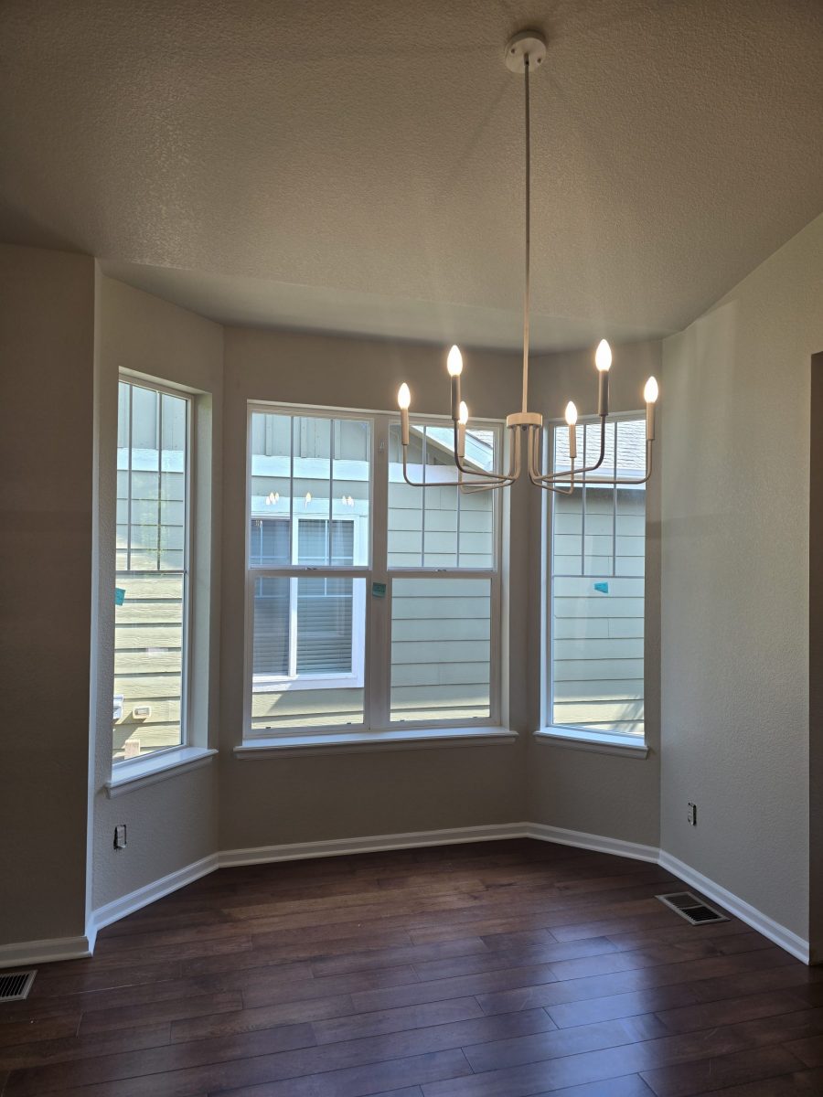 painted room with large windows and chandelier