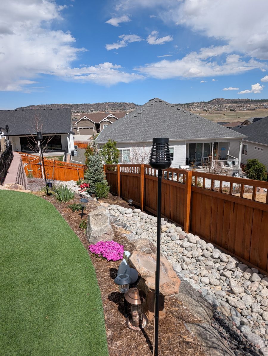 stained wooden fence dividing multiple houses