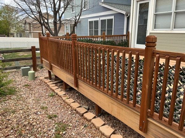 clear stained wooden deck attached to house