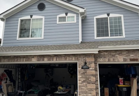 house with garage doors open