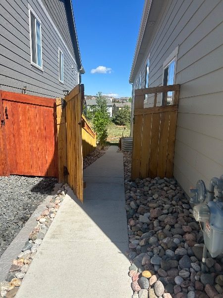 unstained fence gate against house Preview Image 5