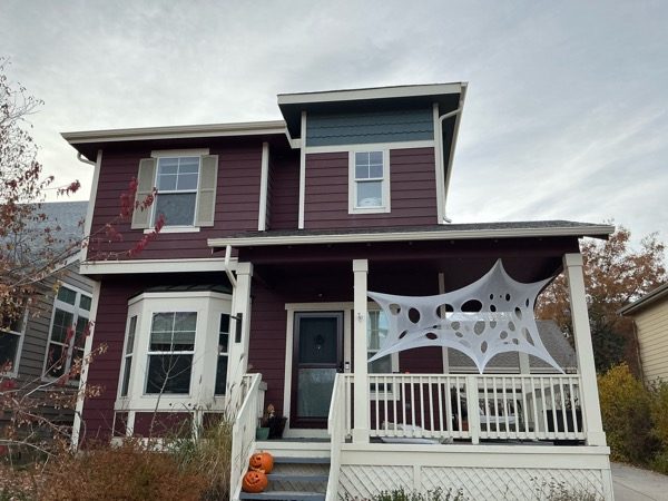 front house exterior with marroon siding and off white porch and trim Preview Image 10
