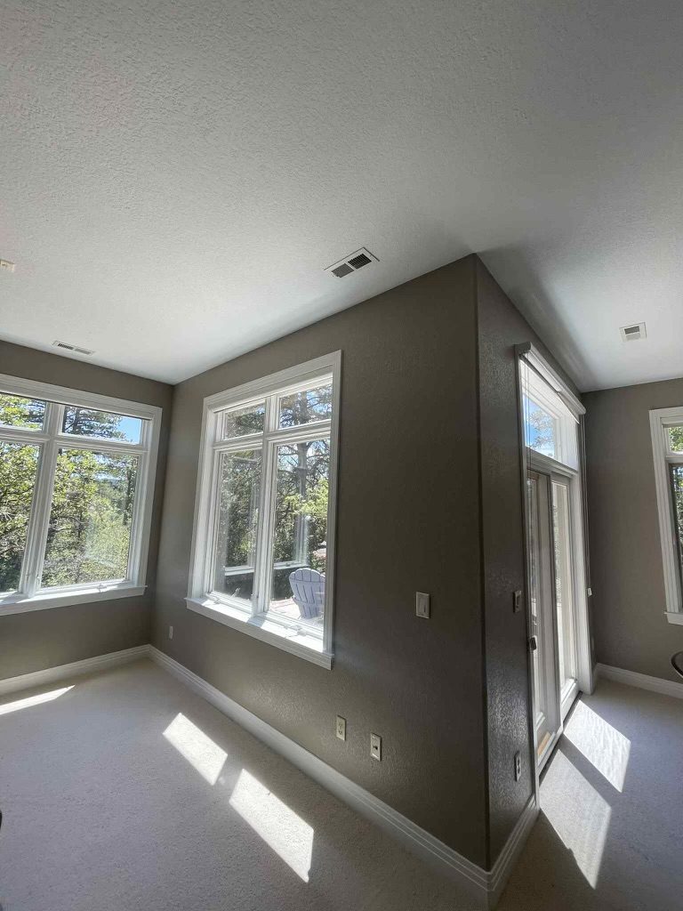 room with large windows and painted wall