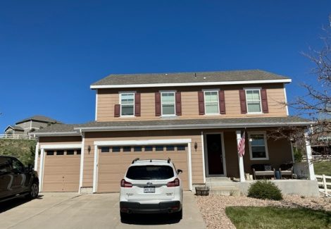 front of house with brown siding before repaint