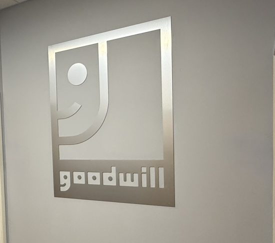 goodwill store sign on gray wall