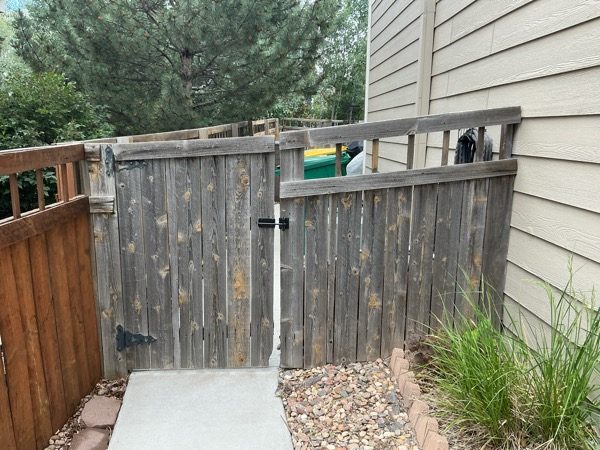 worn wooden fence attached to home Preview Image 5