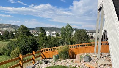 stained fence surrounding house and yard