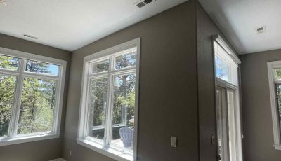 room with large windows and painted wall
