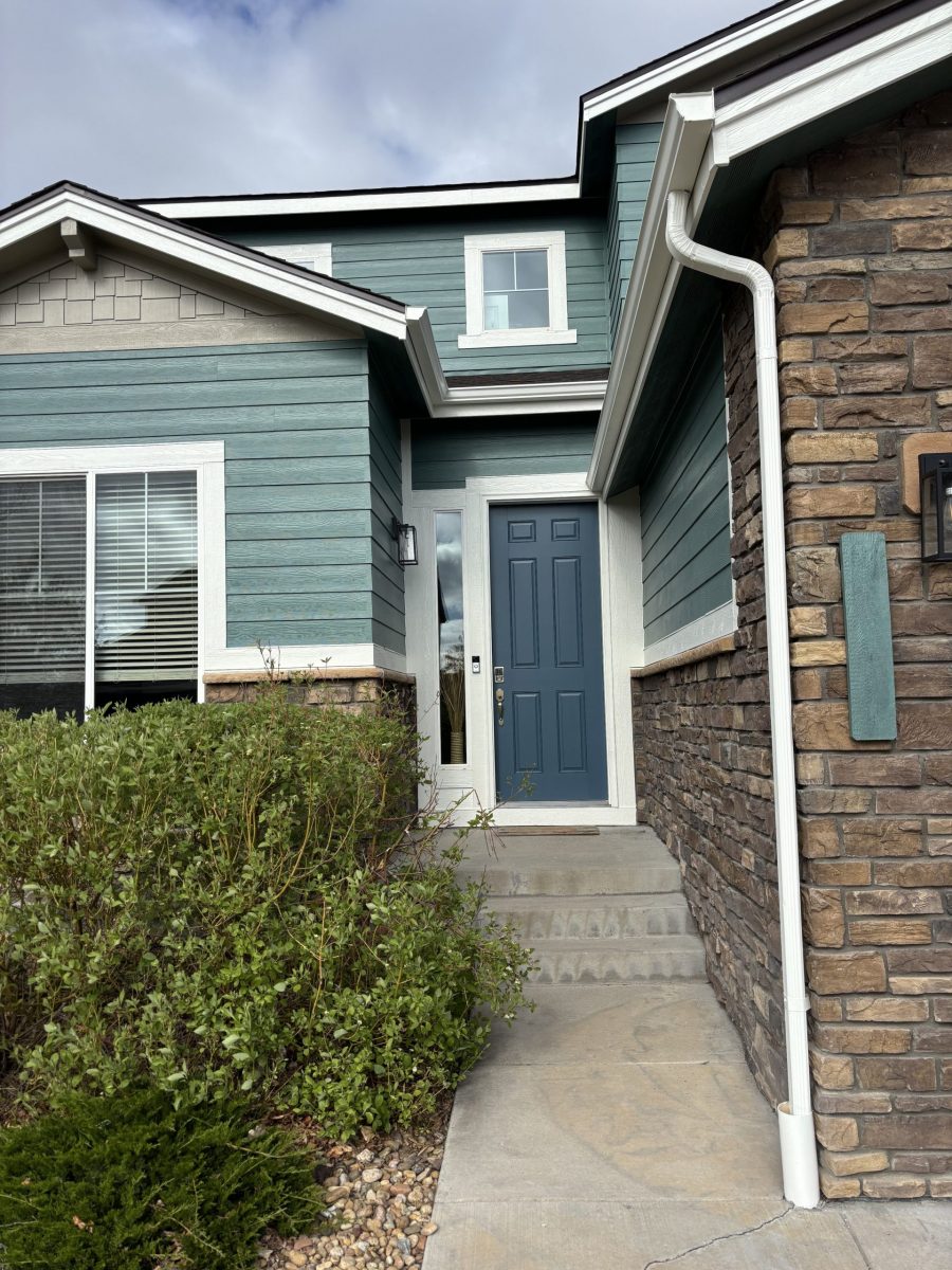 house exterior front entryway with teal and grey siding, blue front door and faux stone siding Preview Image 1