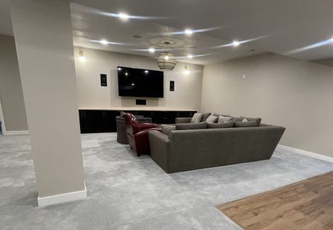 finished basement with couches and tv