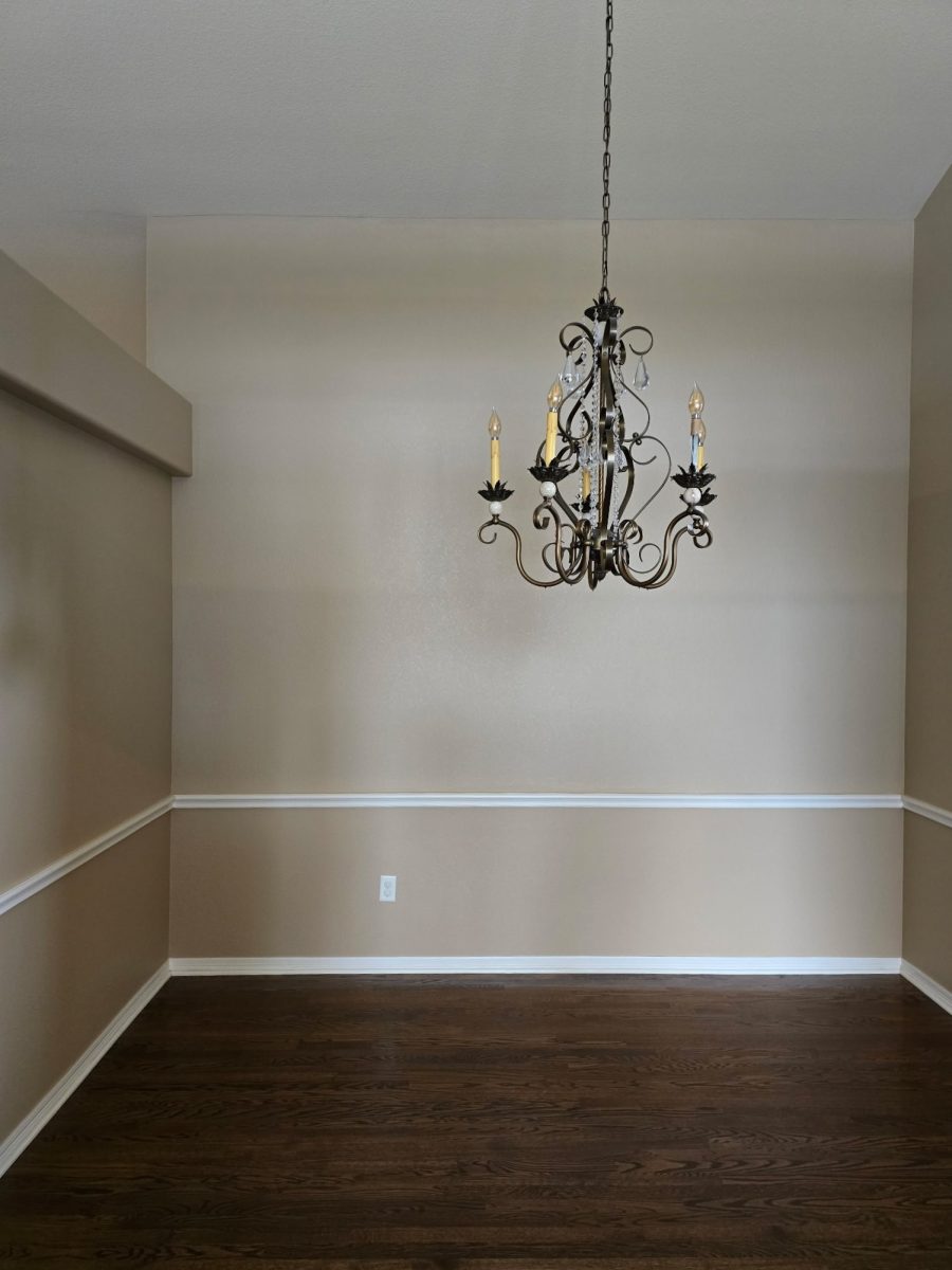 painted interior room with wood floor and chair rail trim