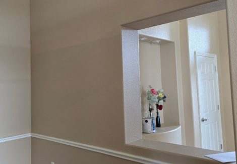 painted interior room with wood floor and chair rail trim