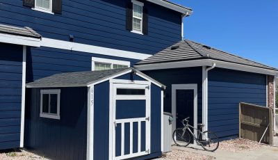 house and detached shed with blue siding