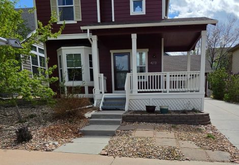 house exterior with marroon siding and white trim
