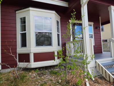 house exterior with dark red and grey painted siding and white trim