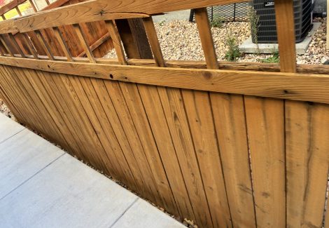 stained wooden fence surrounding house