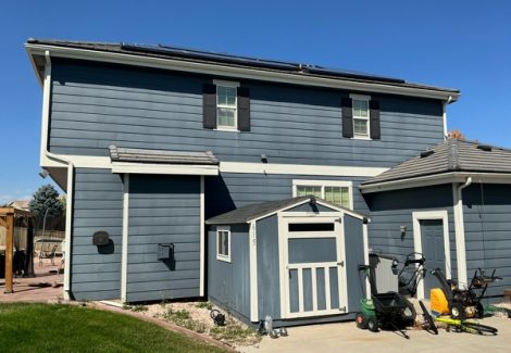 house and shed with aged blue siding