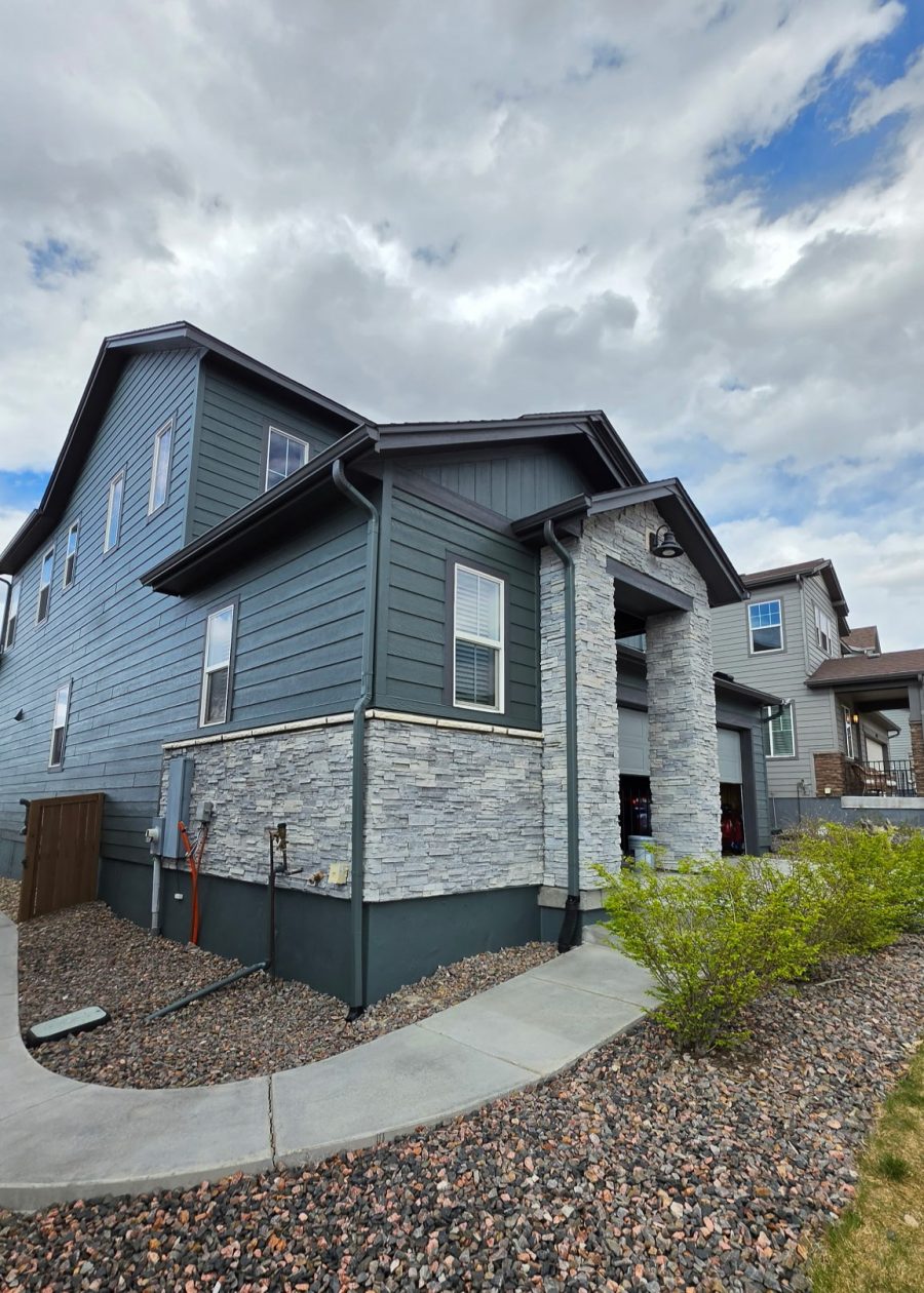 house exterior with dark teal siding after repaint