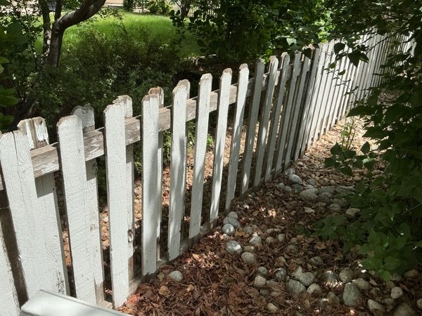 white picket fence with damaged paint Preview Image 4