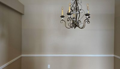 painted interior room with wood floor and chair rail trim