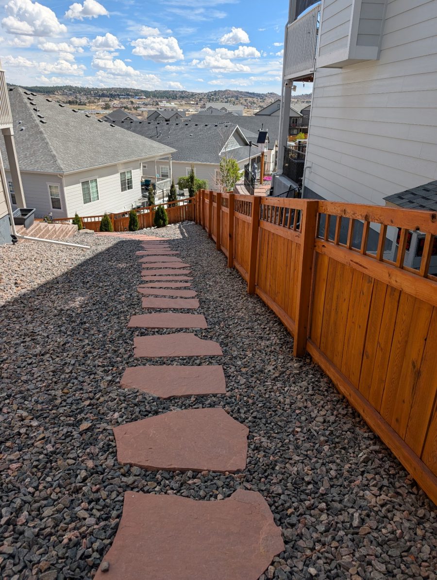gravel ground cover and flat stepping stone path with stained wooden fence between several neighboring houses Preview Image 3