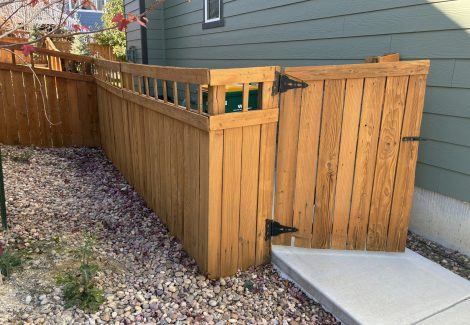 stained wooden fence surrounding house