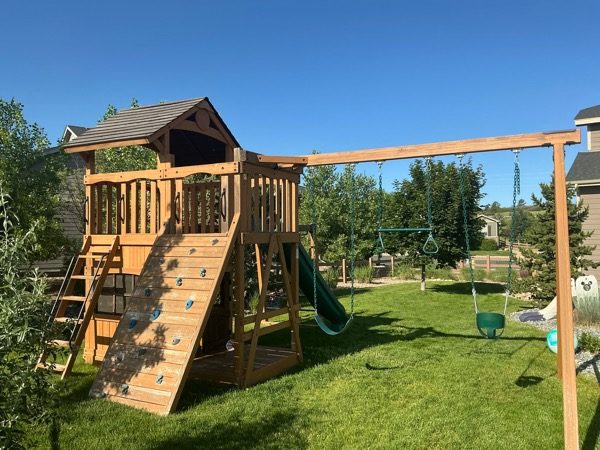 stained wooden playscape in yard Preview Image 4