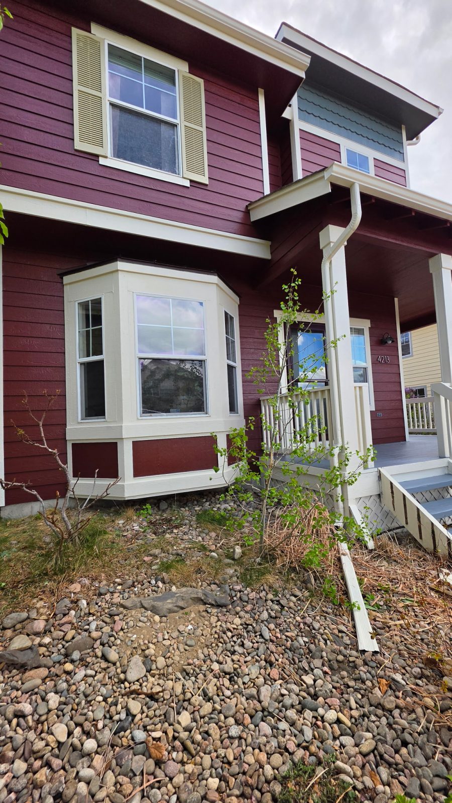 house exterior with dark red and grey painted siding and white trim