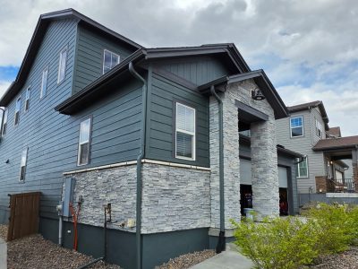 house exterior with dark teal siding after repaint