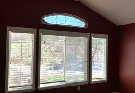 room with dark burgundy wall and large window