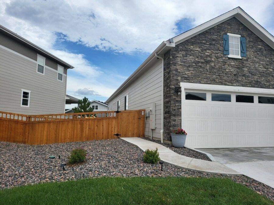 gravel landsaping and stained wooden fence surrounding home Preview Image 3