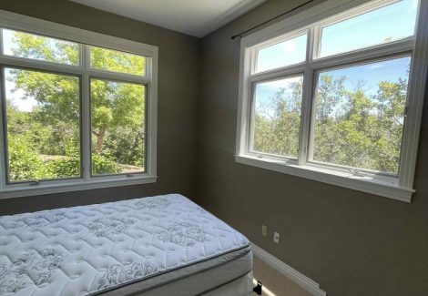 bedroom with bed and large windows