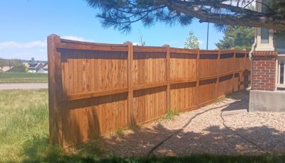 stained wooden fence surrounding yard