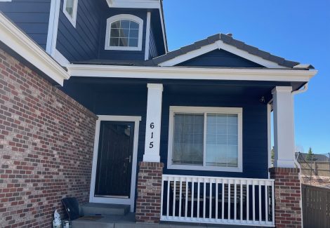 front door and porch of blue painted house