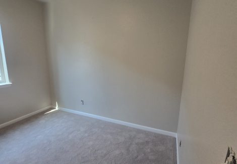 empty room interior with off white walls and carpeting