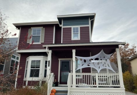 front house exterior with marroon siding and off white porch and trim