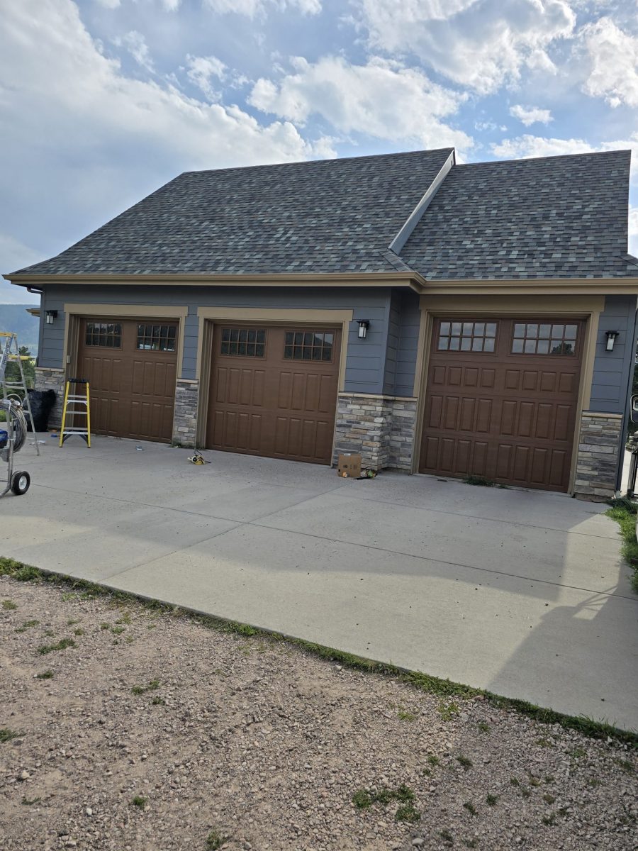 three car garage with brown painted doors