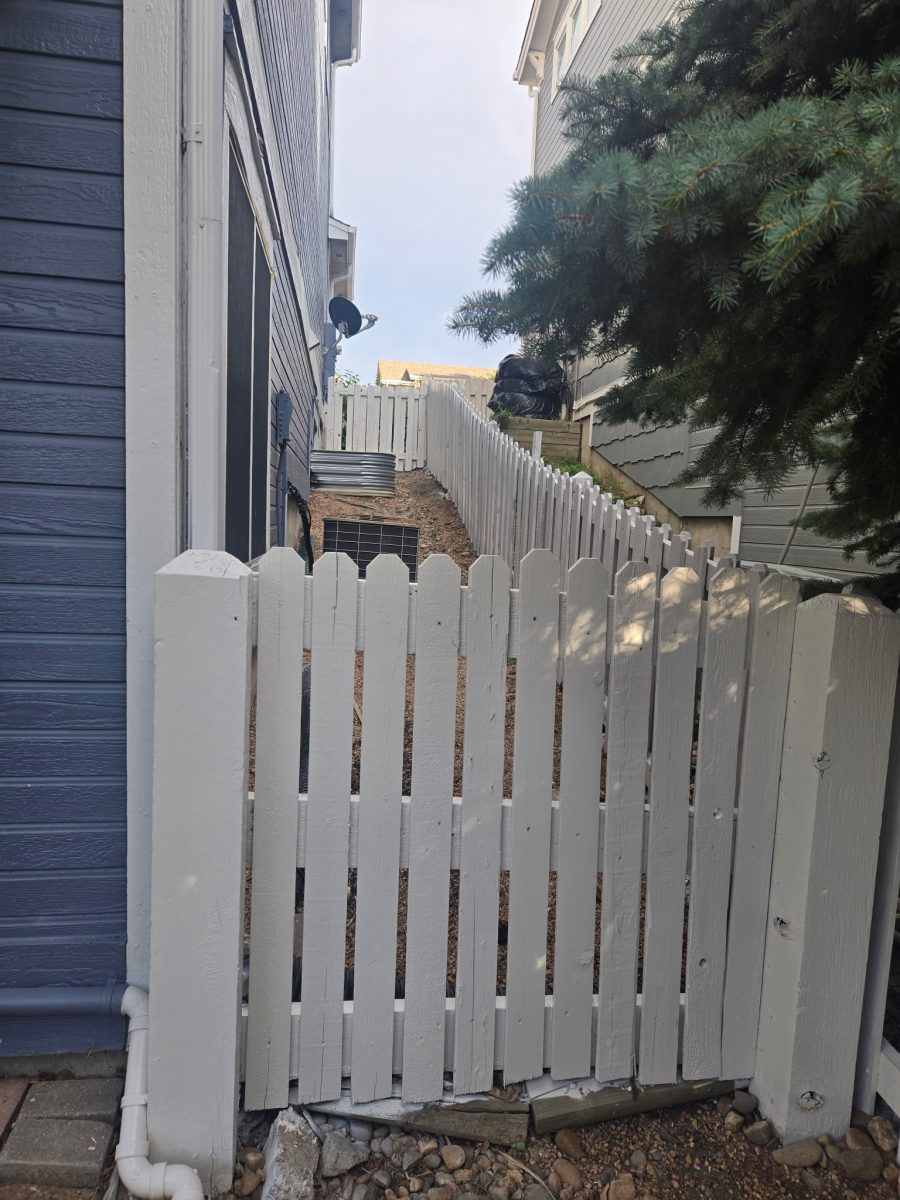 repainted white picket fence against house Preview Image 1