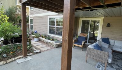 underside of stained wooden deck above patio