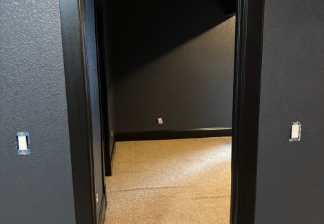 doorway with dark walls and trim