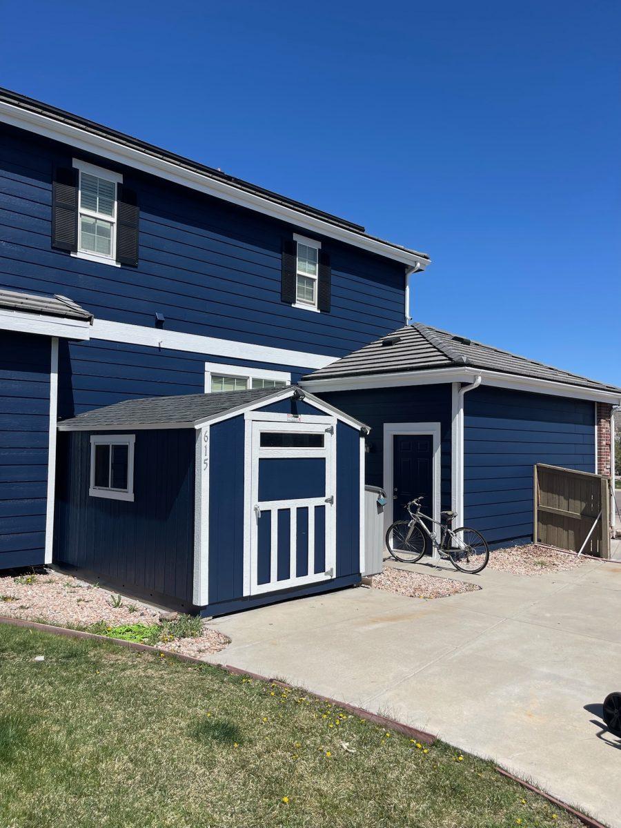 house and detached shed with blue siding