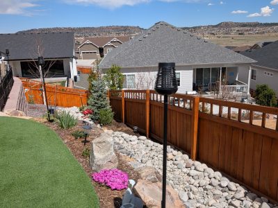 stained wooden fence dividing multiple houses