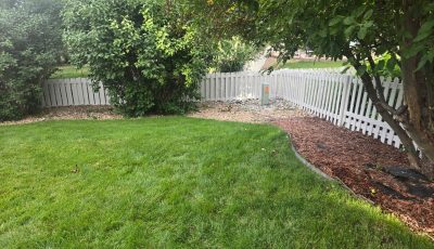 repainted white picket fence surrounding yard
