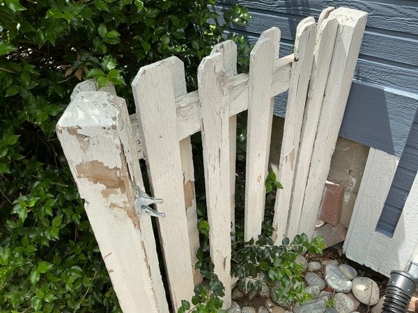 white picket fence with damaged paint Preview Image 5